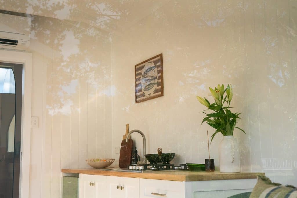 Kitchen benchtop, artwork and raked ceiling inside an Outhaus module