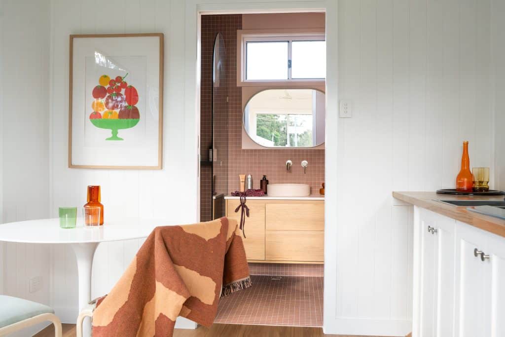 Dining table and bathroom doorway inside an Outhaus modular home