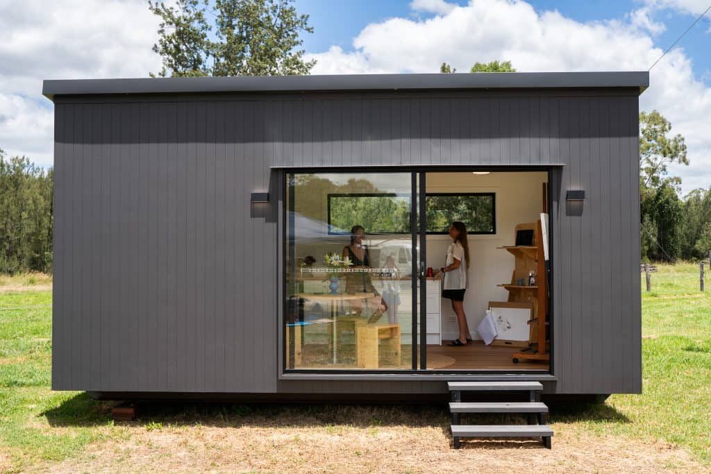Charcoal Outhaus module on a paddock with sliding doors open