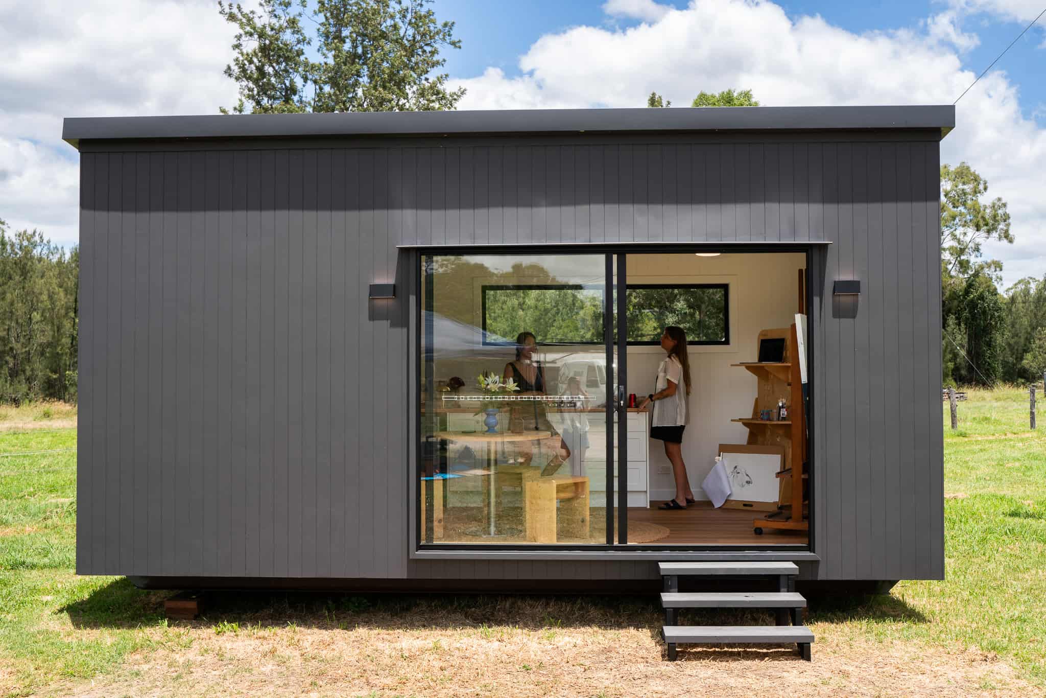 Charcoal Outhaus module on a paddock with sliding doors open